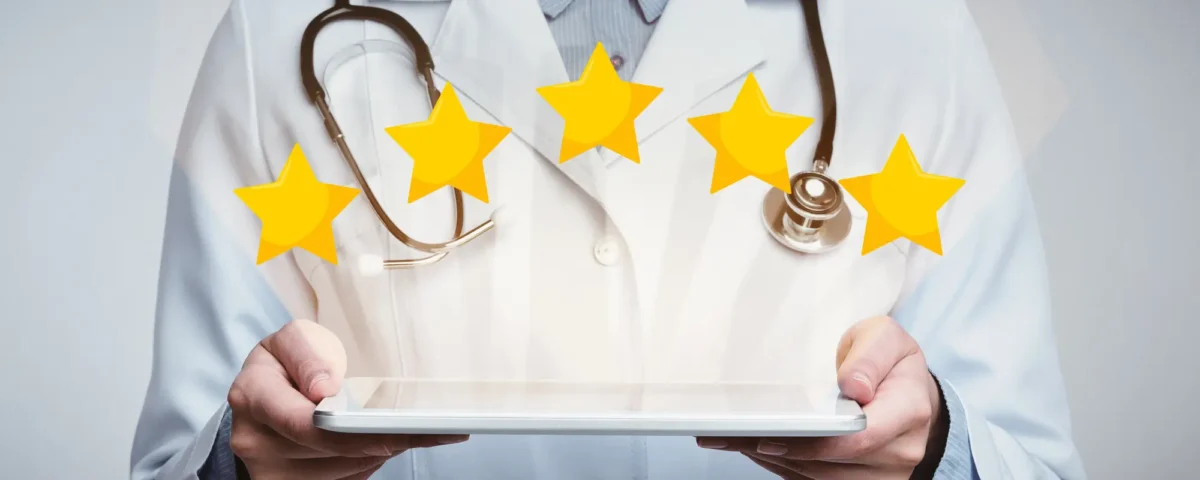 physician holding a tablet with five gold stars above it