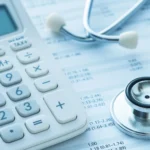 calculator, stethoscope, financial spreadsheet