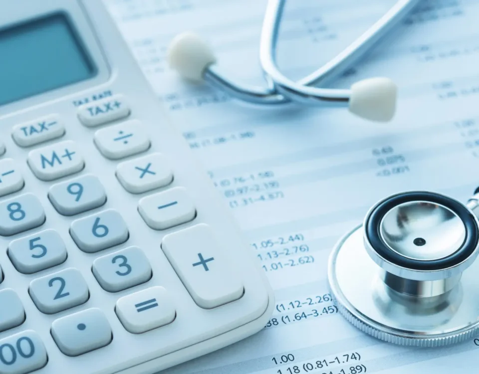 calculator, stethoscope, financial spreadsheet